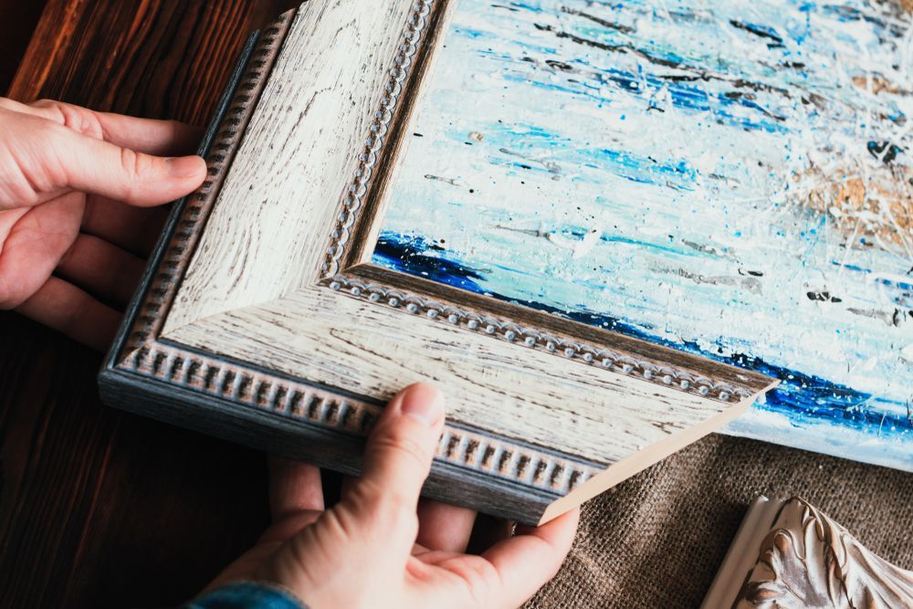 Woman's Hands and Sample of Wooden Frame — Picture Framing in Lammermoor, QLD