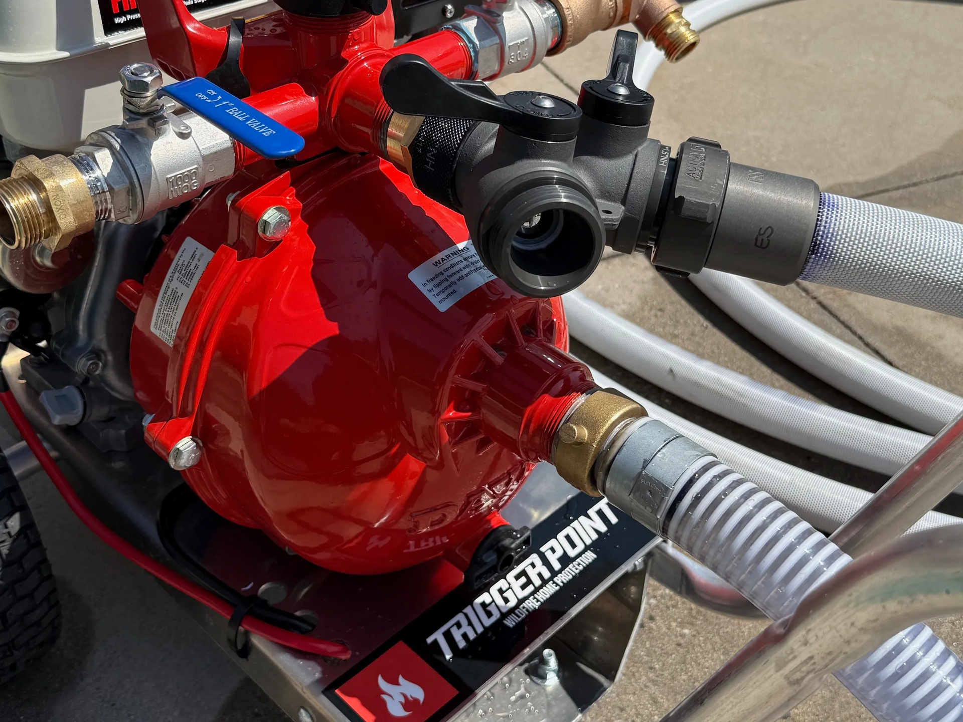 Red water pump with hoses, valves, and a 