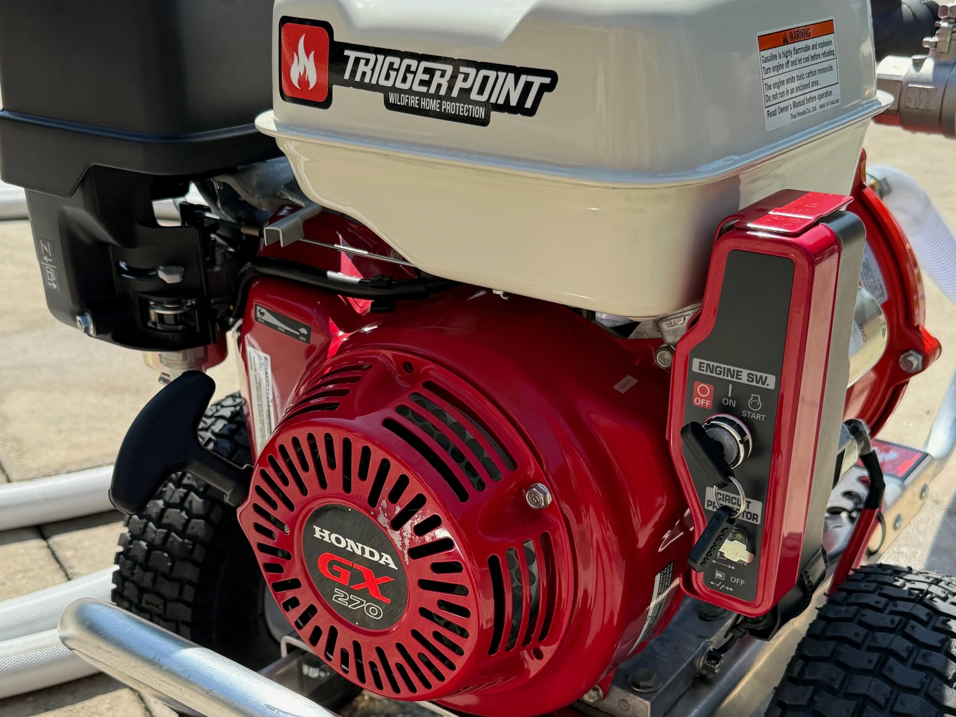 Red and white Honda engine on a pump with 