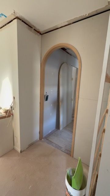 Empty Hallway with An Arched Doorway, Beige Walls, and A Tiled Floor — JPR Concepts in Burleigh Heads, QLD