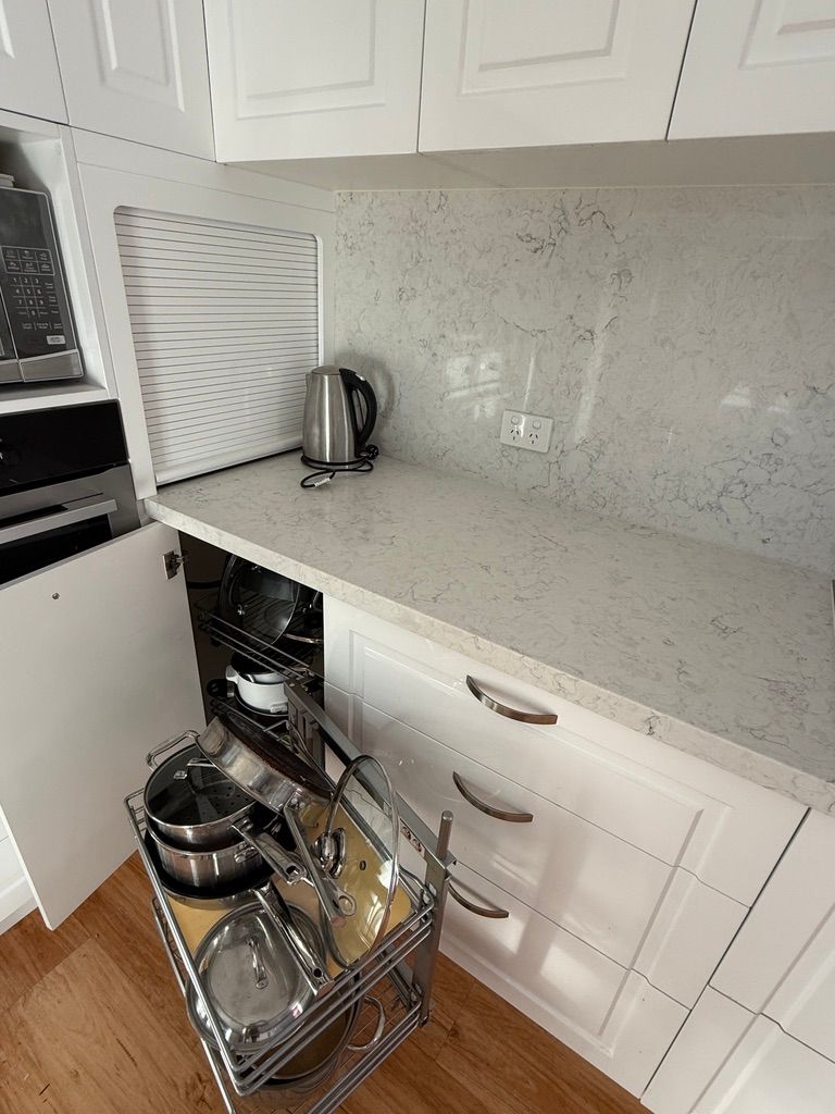 White Kitchen Counter with A Kettle and Open Pull Out Shelf — JPR Concepts in Burleigh Heads, QLD