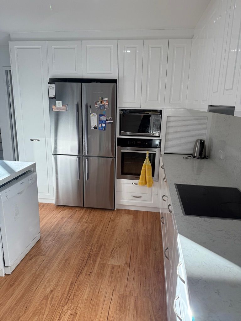 Modern White Kitchen with Light Wood Floor, and Gray Countertops — JPR Concepts in Burleigh Heads, QLD