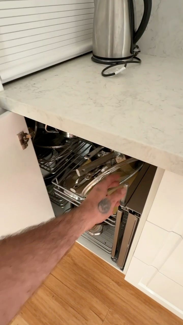 Hand Reaching Into an Open Under Counter Drawer Beside a Kitchen Countertop — JPR Concepts in Burleigh Heads, QLD