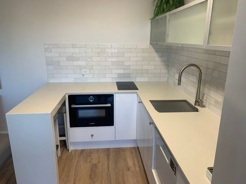 Modern White Kitchen with L Shaped Countertop — JPR Concepts in Burleigh Heads, QLD