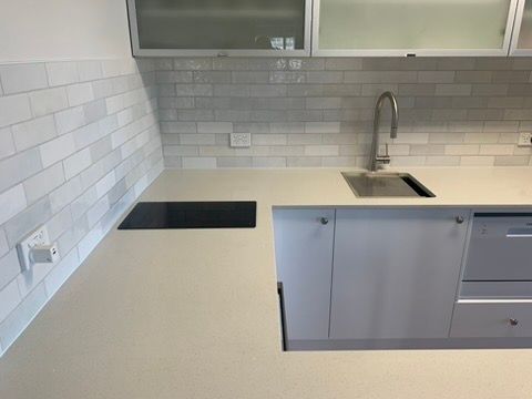 Modern Kitchen with White Tile Backsplash and Gray Cabinets — JPR Concepts in Burleigh Heads, QLD