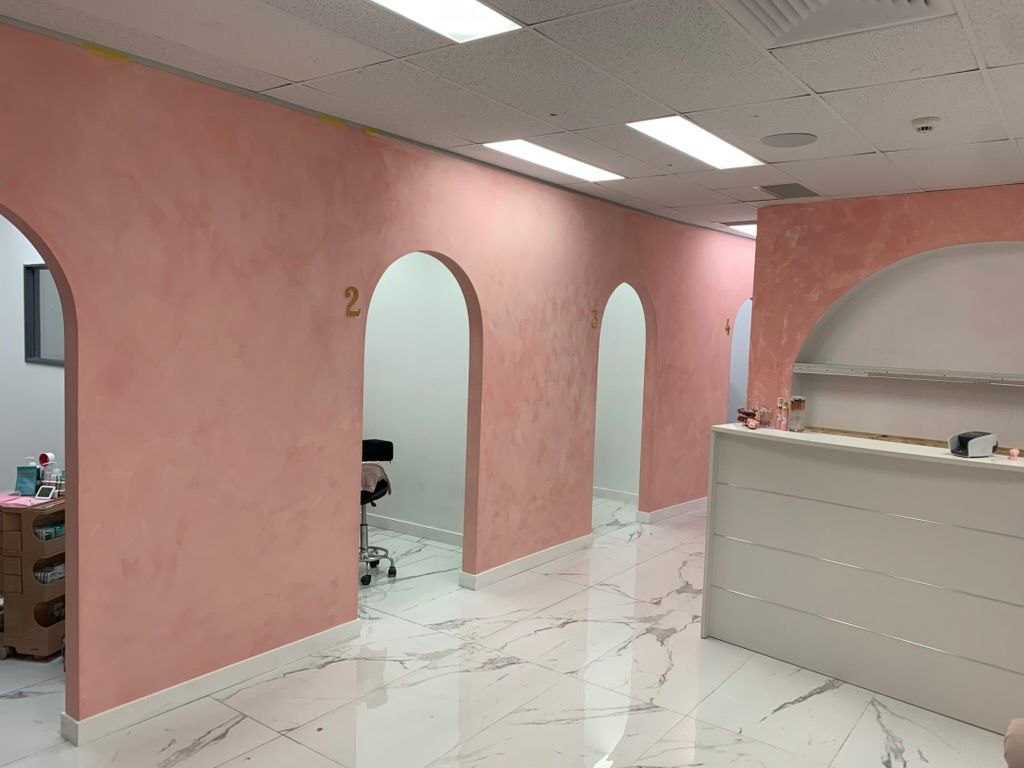 Pink Walled Salon Interior with Arched Doorways and A Reception Counter — JPR Concepts in Burleigh Heads, QLD