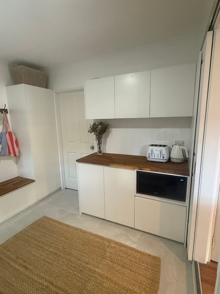 Bright Kitchen with White Cabinets and Wood Countertops — JPR Concepts in Burleigh Heads, QLD