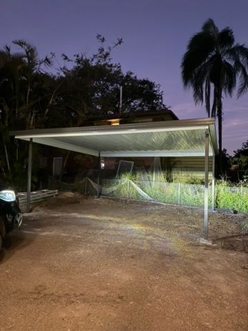 Nighttime View of A Lit Carport with A Dirt Driveway — JPR Concepts in Burleigh Heads, QLD