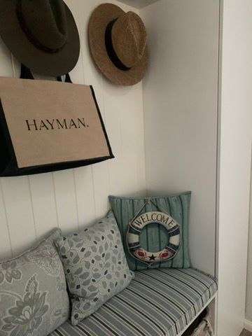 Cozy Corner with Hanging Hats, a Hayman Tote, Patterned Pillows, and A Striped Bench — JPR Concepts in Burleigh Heads, QLD