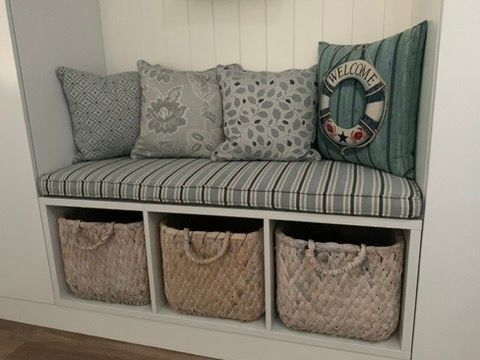 Cozy Bench Seat with Cushion, Patterned Pillows, and Woven Storage Baskets Underneath — JPR Concepts in Burleigh Heads, QLD