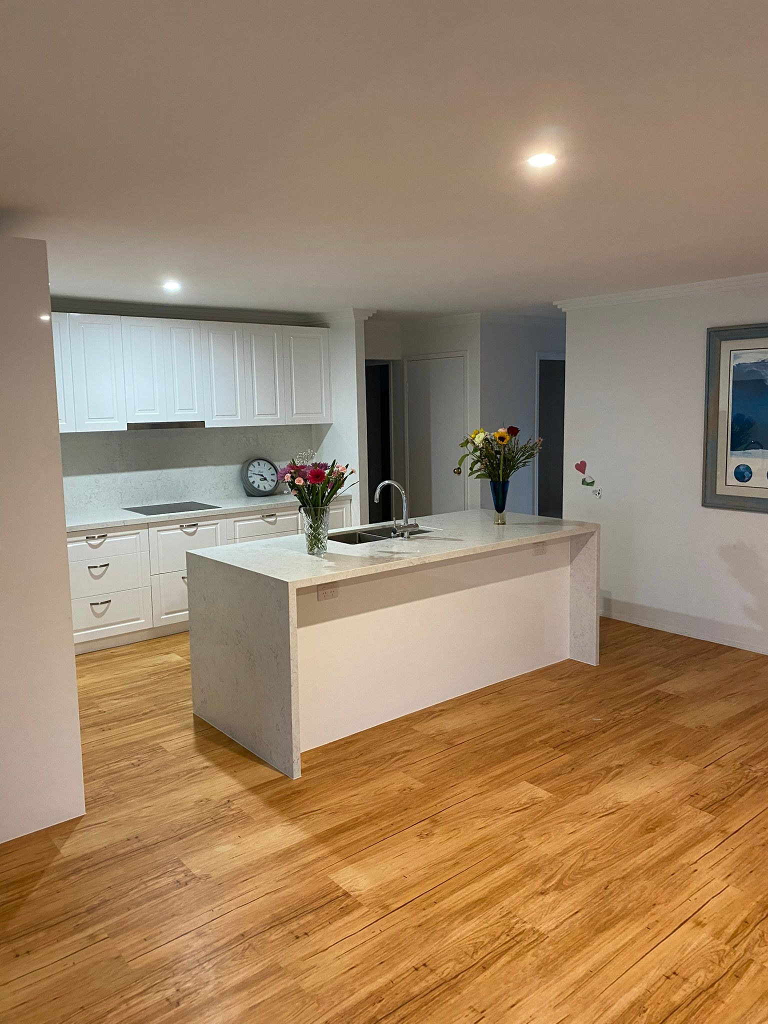 Bright Kitchen with White Cabinets and Hardwood Floors — JPR Concepts in Burleigh Heads, QLD