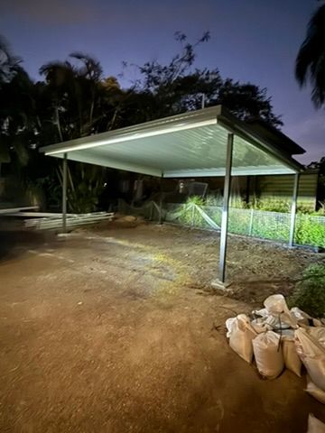 Lit Carport with Metal Roof Over Dirt Ground at Dusk — JPR Concepts in Burleigh Heads, QLD