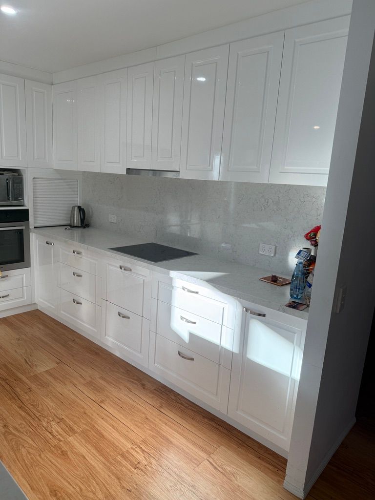 Bright White Kitchen with Cabinets and Gray Backsplash — JPR Concepts in Burleigh Heads, QLD
