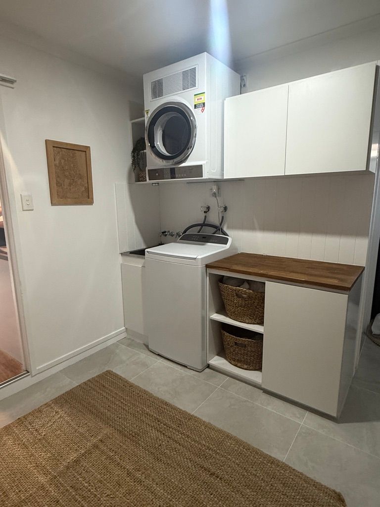Small Laundry Room with Stacked Washer and Dryer — JPR Concepts in Burleigh Heads, QLD