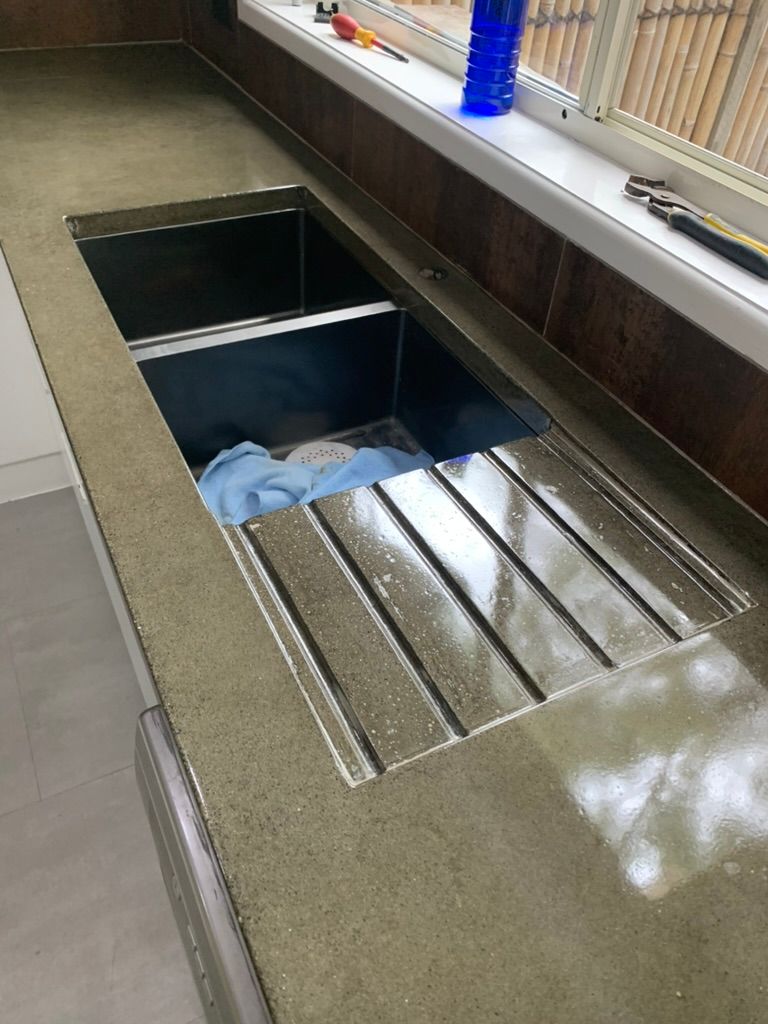 Metal Sink with Drying Rack and A Blue Cloth in A Kitchen Counter Area — JPR Concepts in Burleigh Heads, QLD