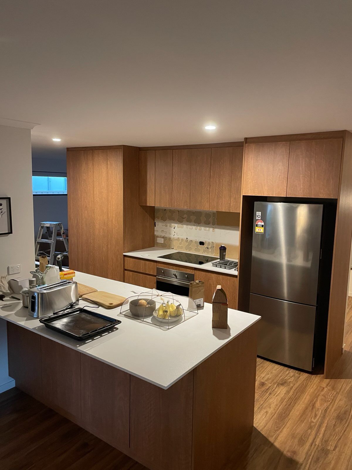 Modern Kitchen with Wood Cabinets, Stainless Steel Appliances, and An Island Countertop — JPR Concepts in Burleigh Heads, QLD