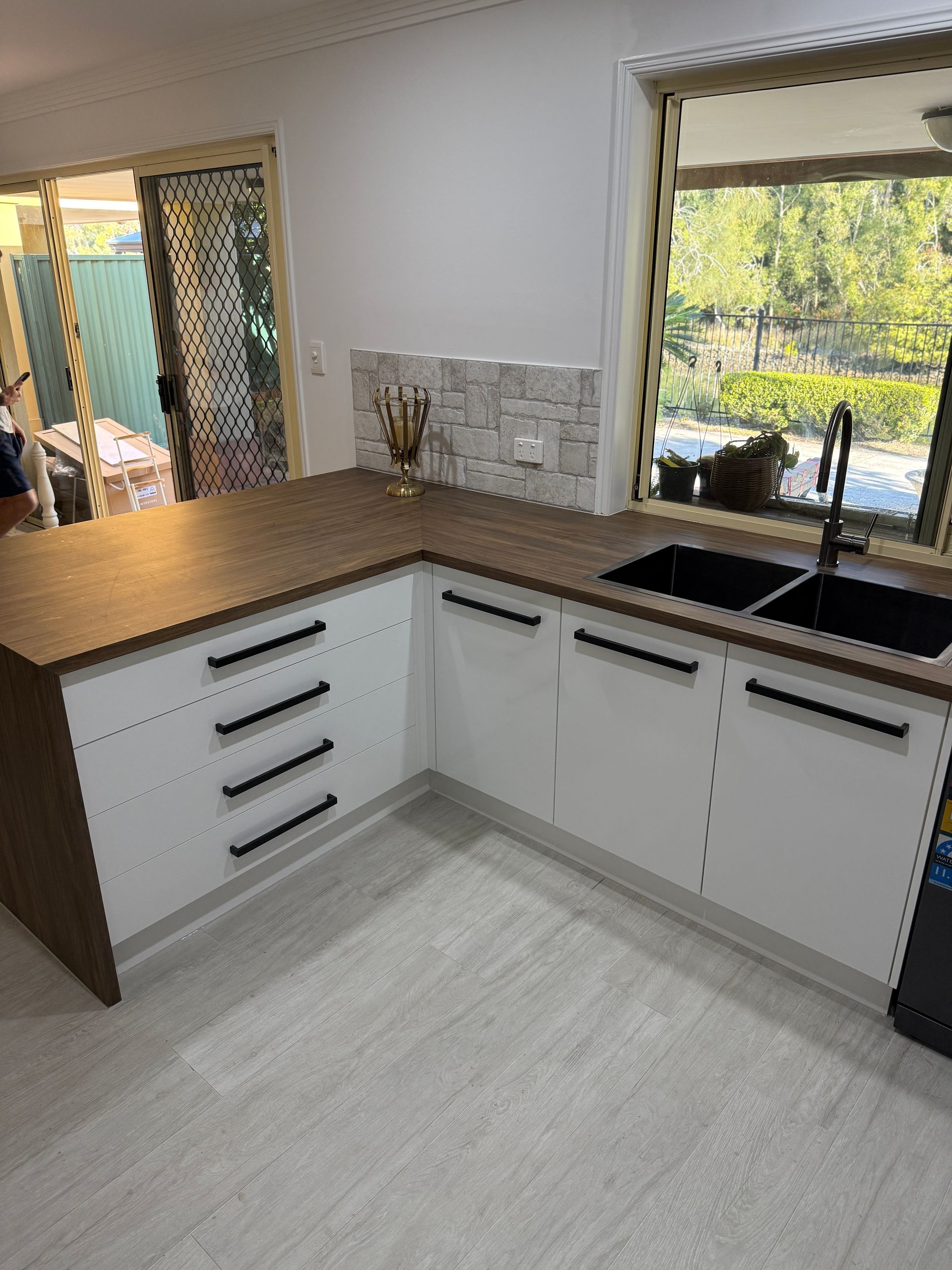 Modern Kitchen Corner with White Cabinets and Wooden Countertop — JPR Concepts in Burleigh Heads, QLD