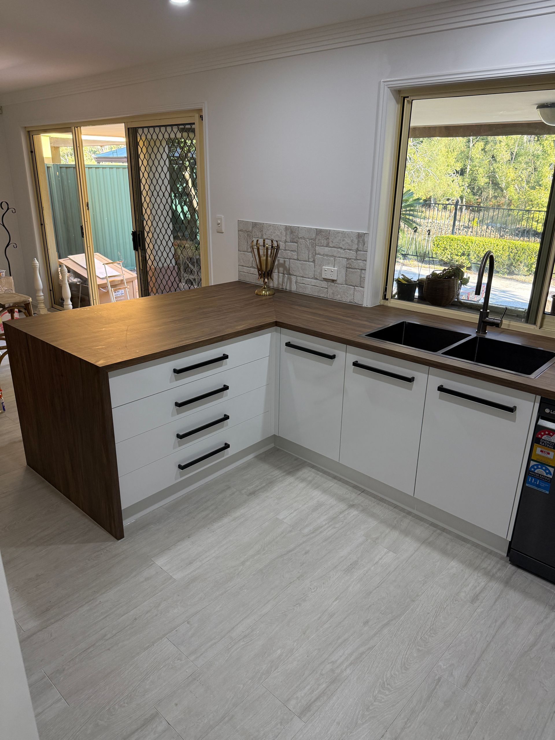 Modern Kitchen with White Cabinets, Wood Countertop Island, and Tiled Backsplash — JPR Concepts in Burleigh Heads, QLD