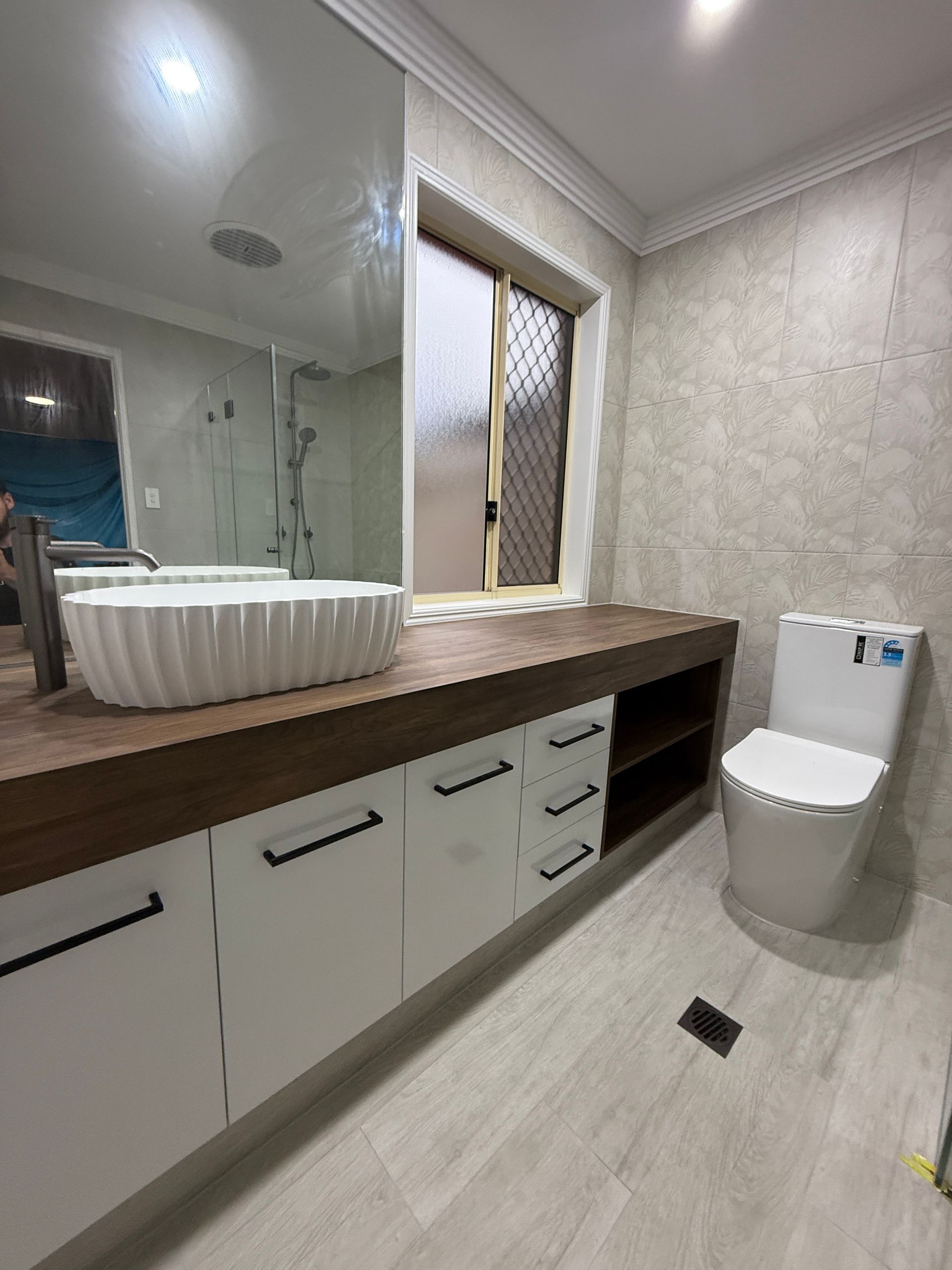 Modern Bathroom with Vanity and Toilet on Light Tile Floor — JPR Concepts in Burleigh Heads, QLD