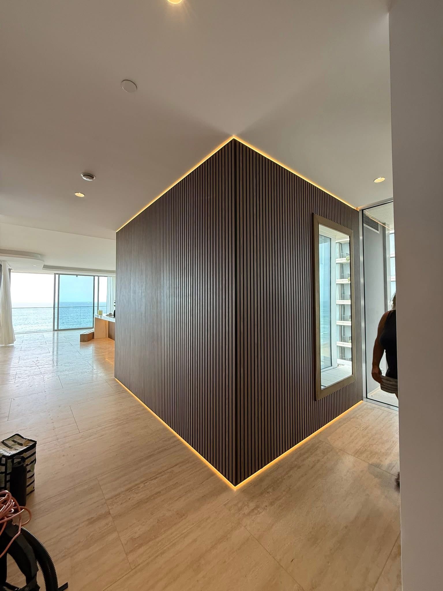Modern Apartment Interior with Curved Dark Feature Wall and Warm Wood Floors — JPR Concepts in Burleigh Heads, QLD