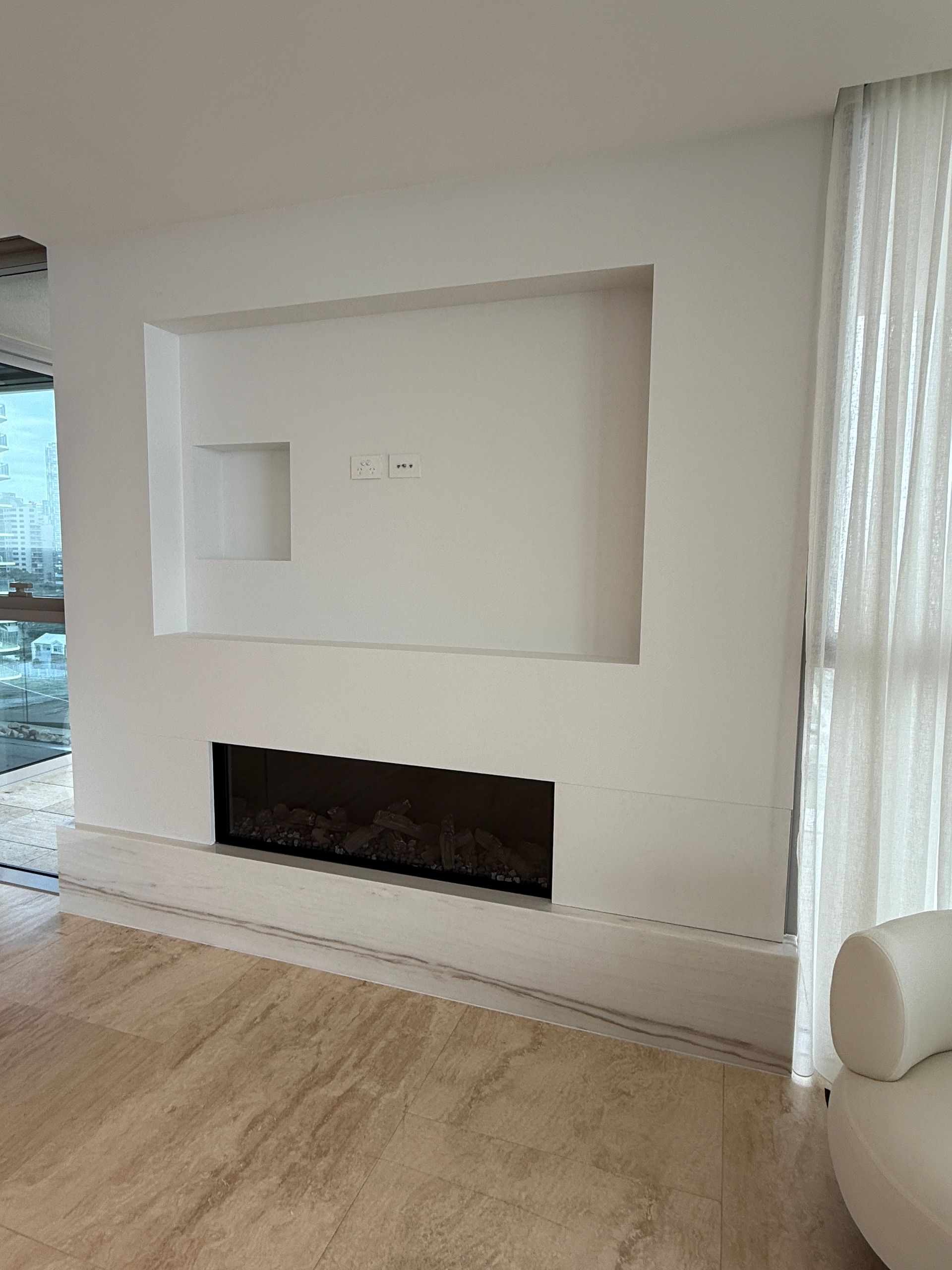Modern Living Room Wall with Recessed Shelves, a Fireplace, and Light Wood Flooring — JPR Concepts in Burleigh Heads, QLD