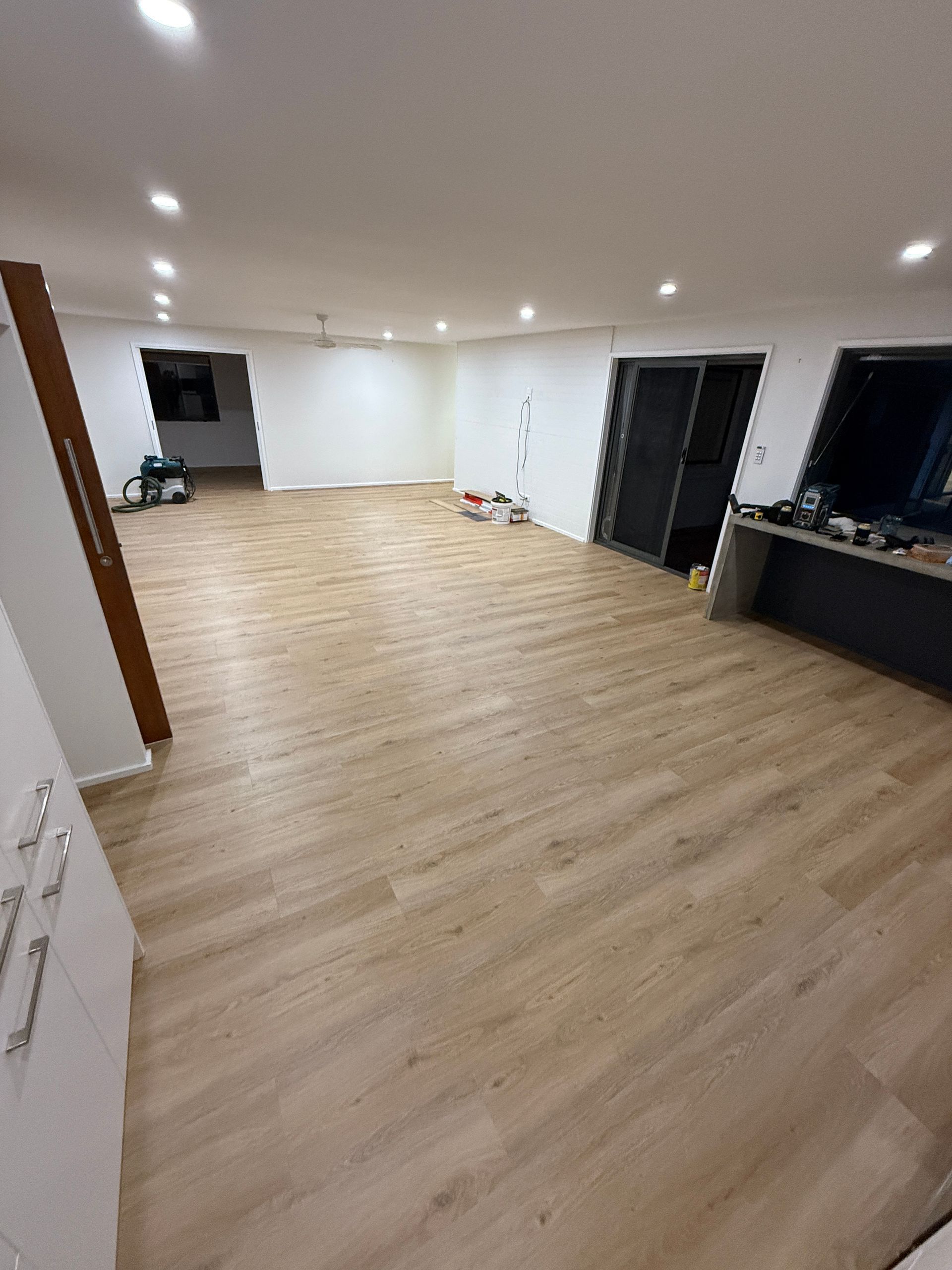 Empty Modern Living Room with Light Wood Floors and Dark Windows and Doors — JPR Concepts in Burleigh Heads, QLD