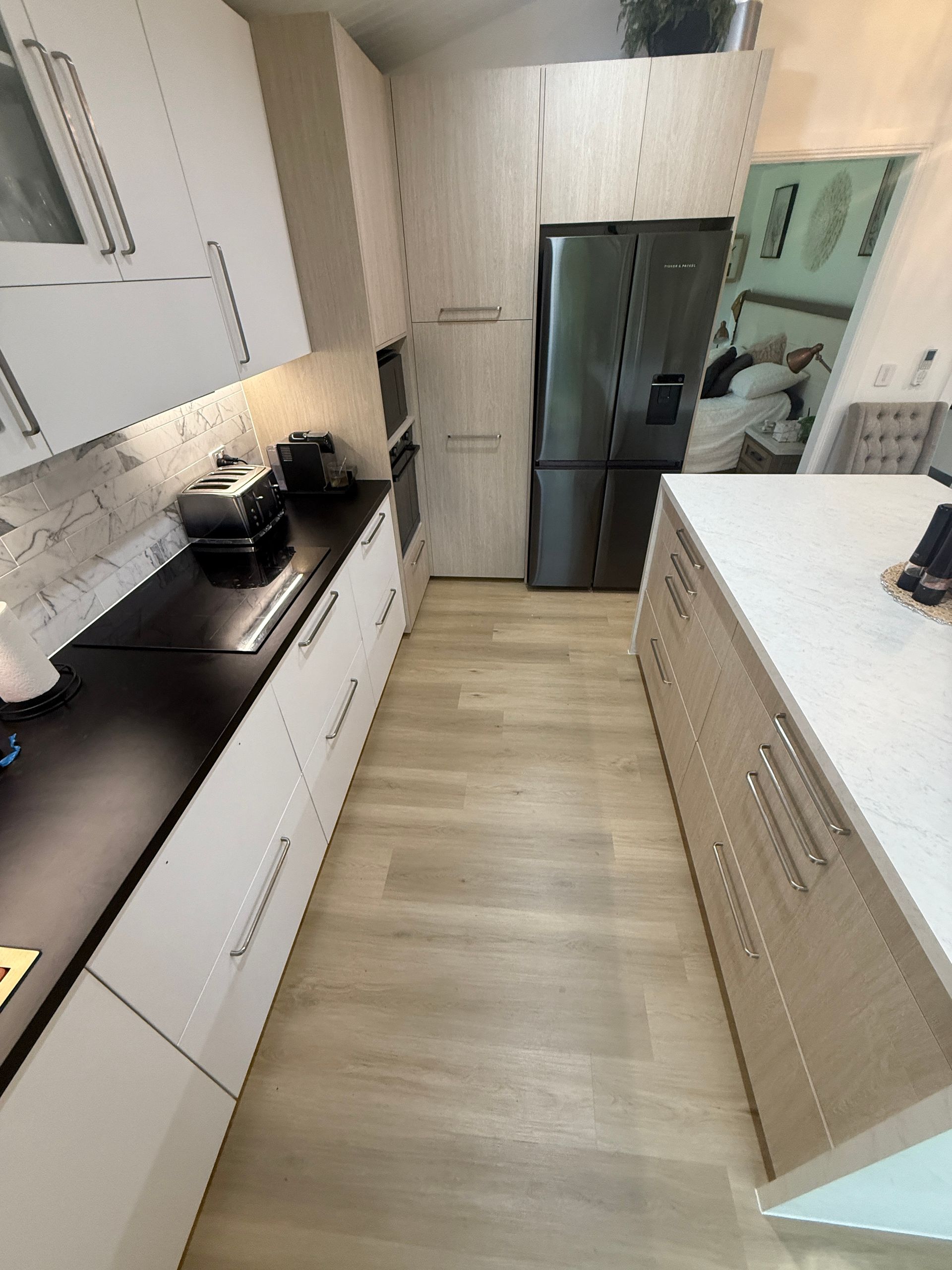 Narrow Modern Kitchen with White Cabinets and Black Countertops — JPR Concepts in Burleigh Heads, QLD