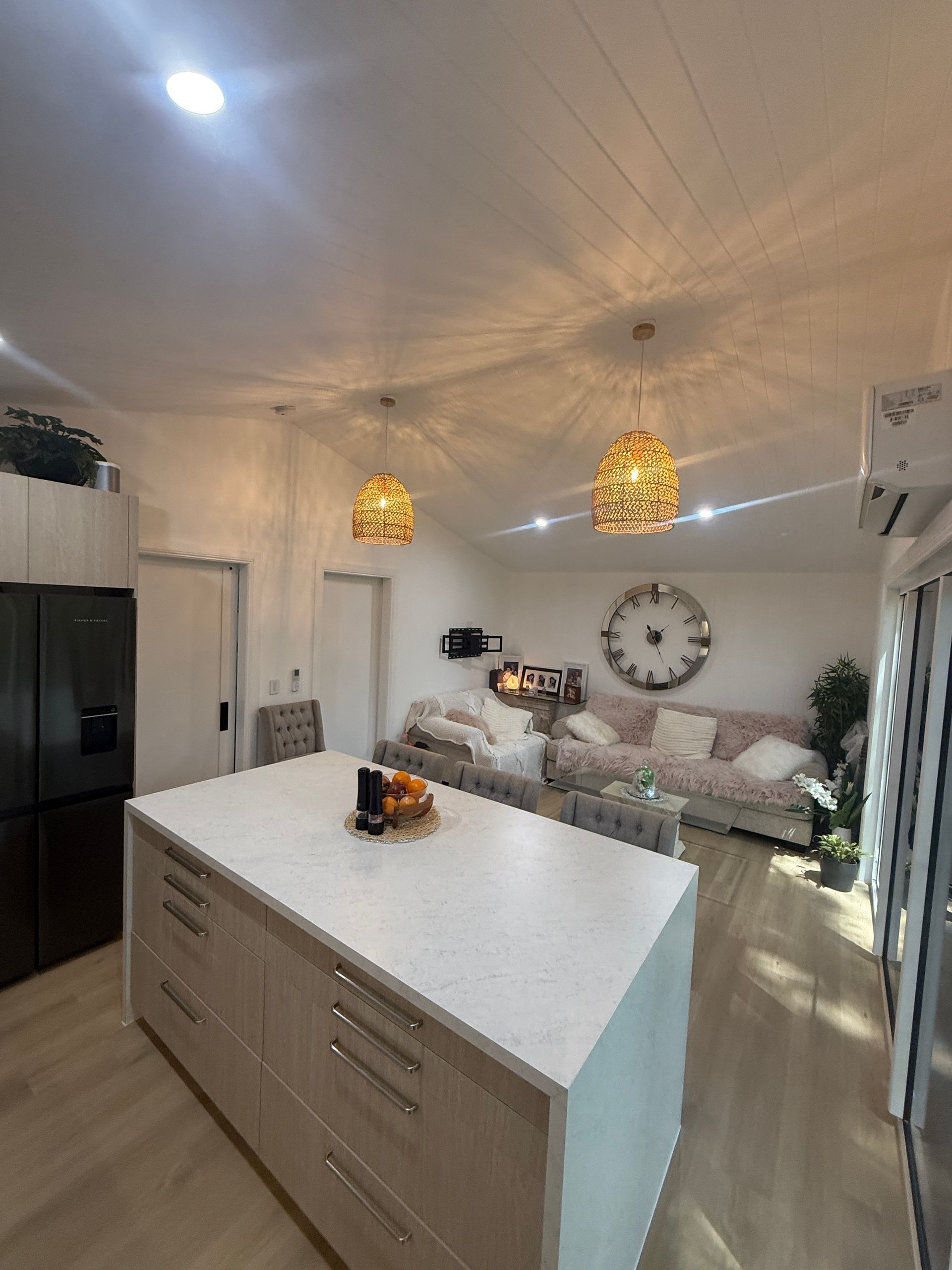 Modern Open Kitchen and Living Room with White Island — JPR Concepts in Burleigh Heads, QLD