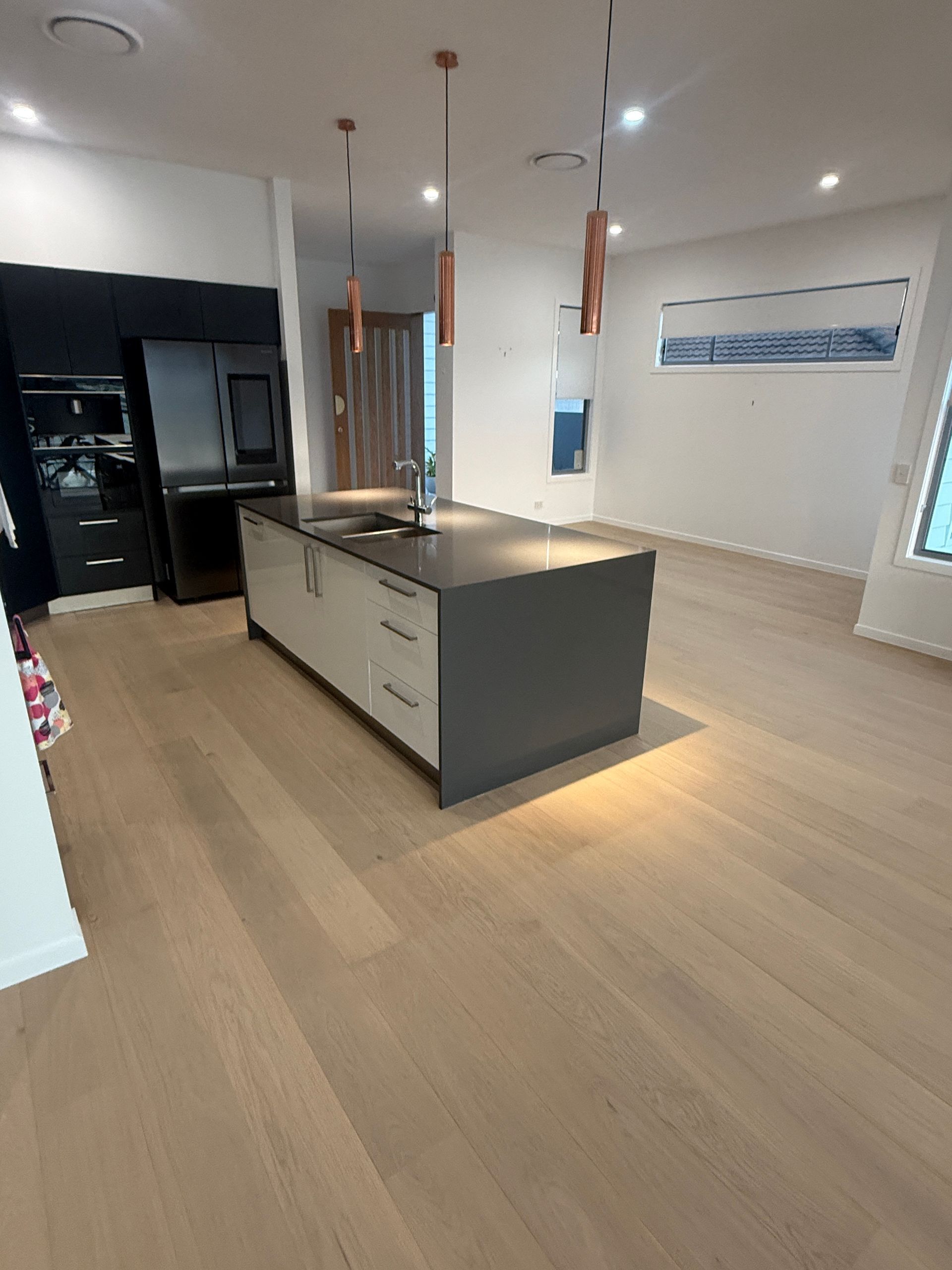 Modern Kitchen with A Large Island and Light Wood Flooring — JPR Concepts in Burleigh Heads, QLD