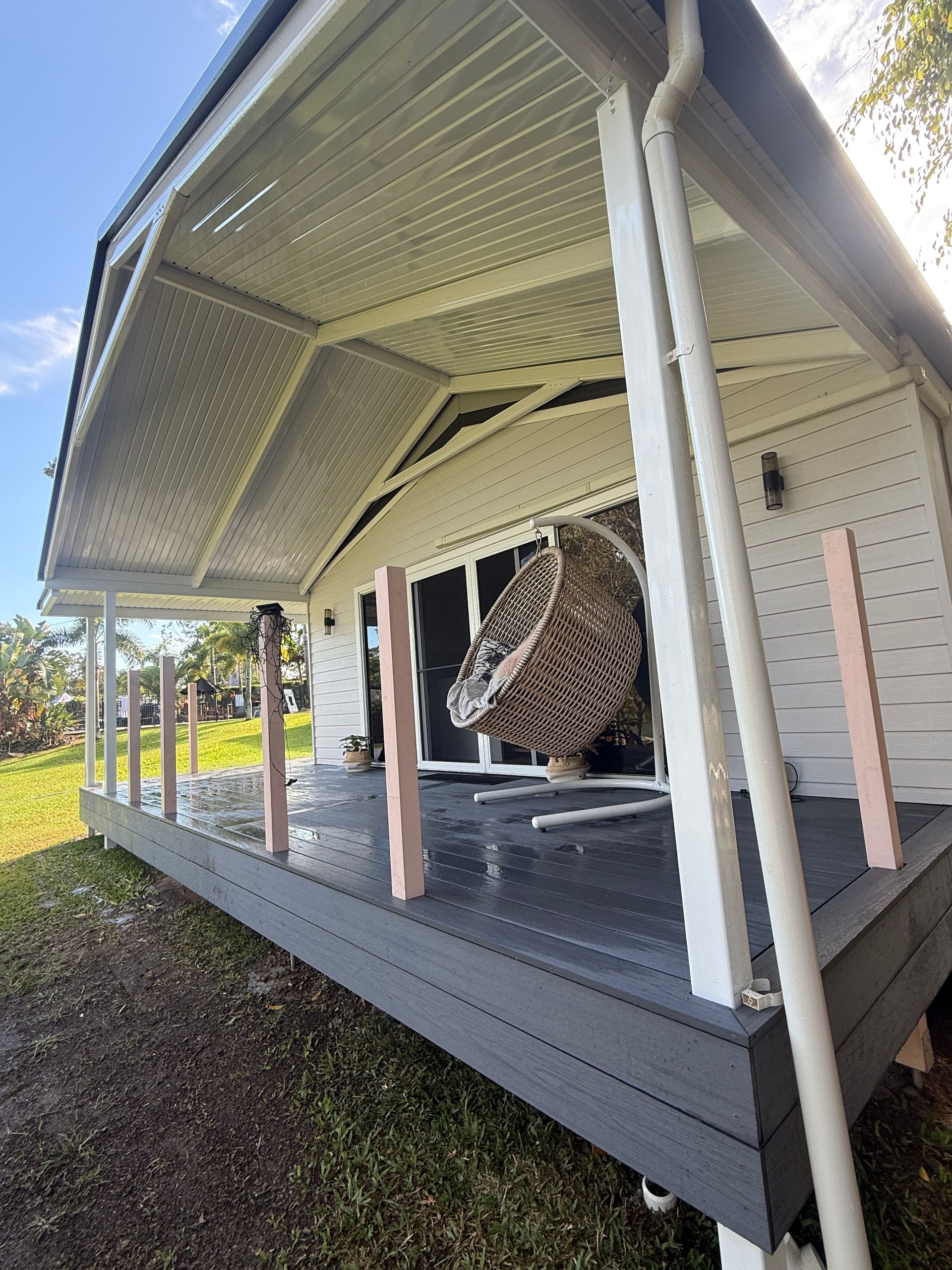 Covered Porch with White Posts and Gray Deck — JPR Concepts in Burleigh Heads, QLD