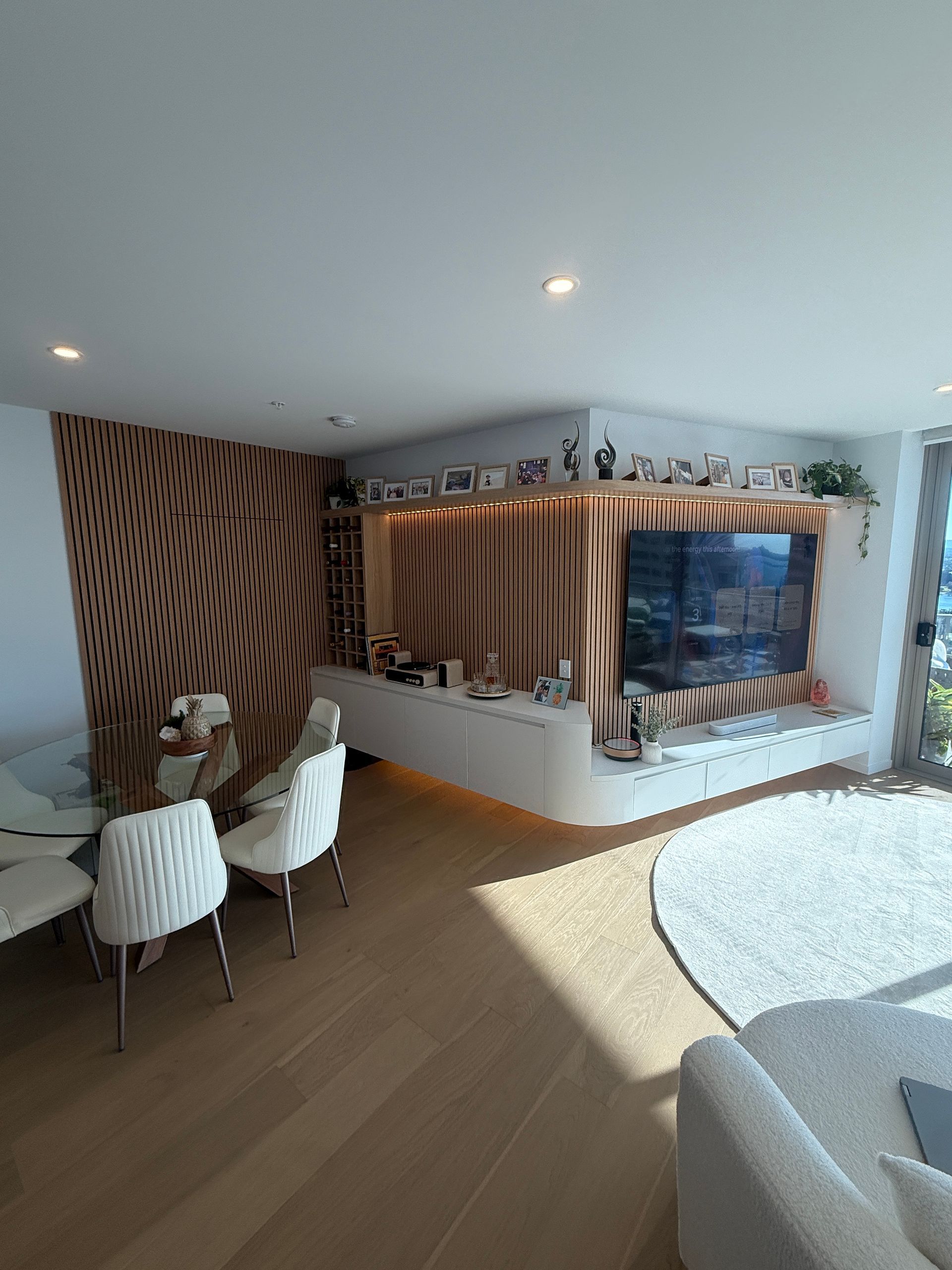 Modern Living Room with Curved Wood Wall — JPR Concepts in Burleigh Heads, QLD