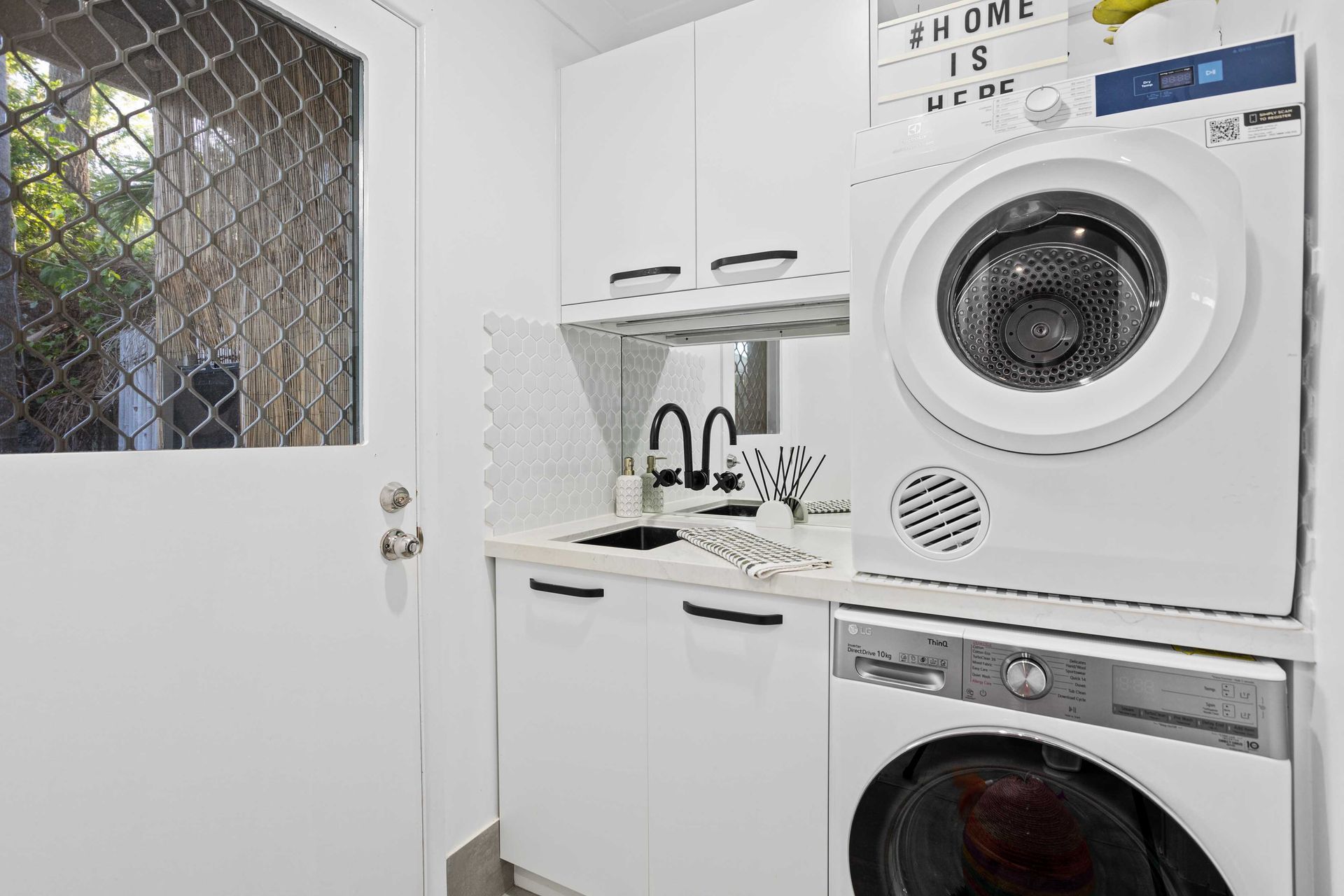 Compact Laundry Nook with Stacked Washer and Dryer — JPR Concepts in Burleigh Heads, QLD