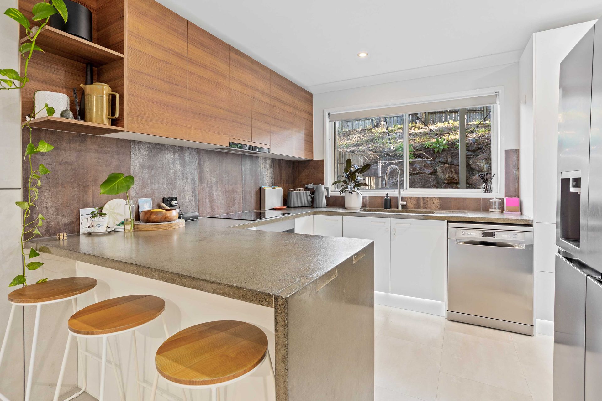 Modern Kitchen with Wood Cabinets and Granite Island — JPR Concepts in Burleigh Heads, QLD