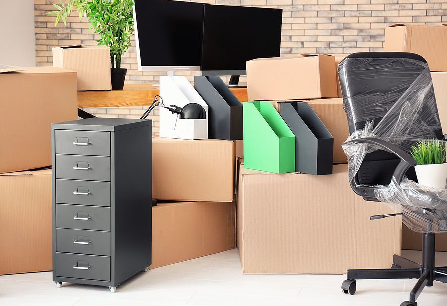 Office moving supplies including boxes and a filing cabinet.