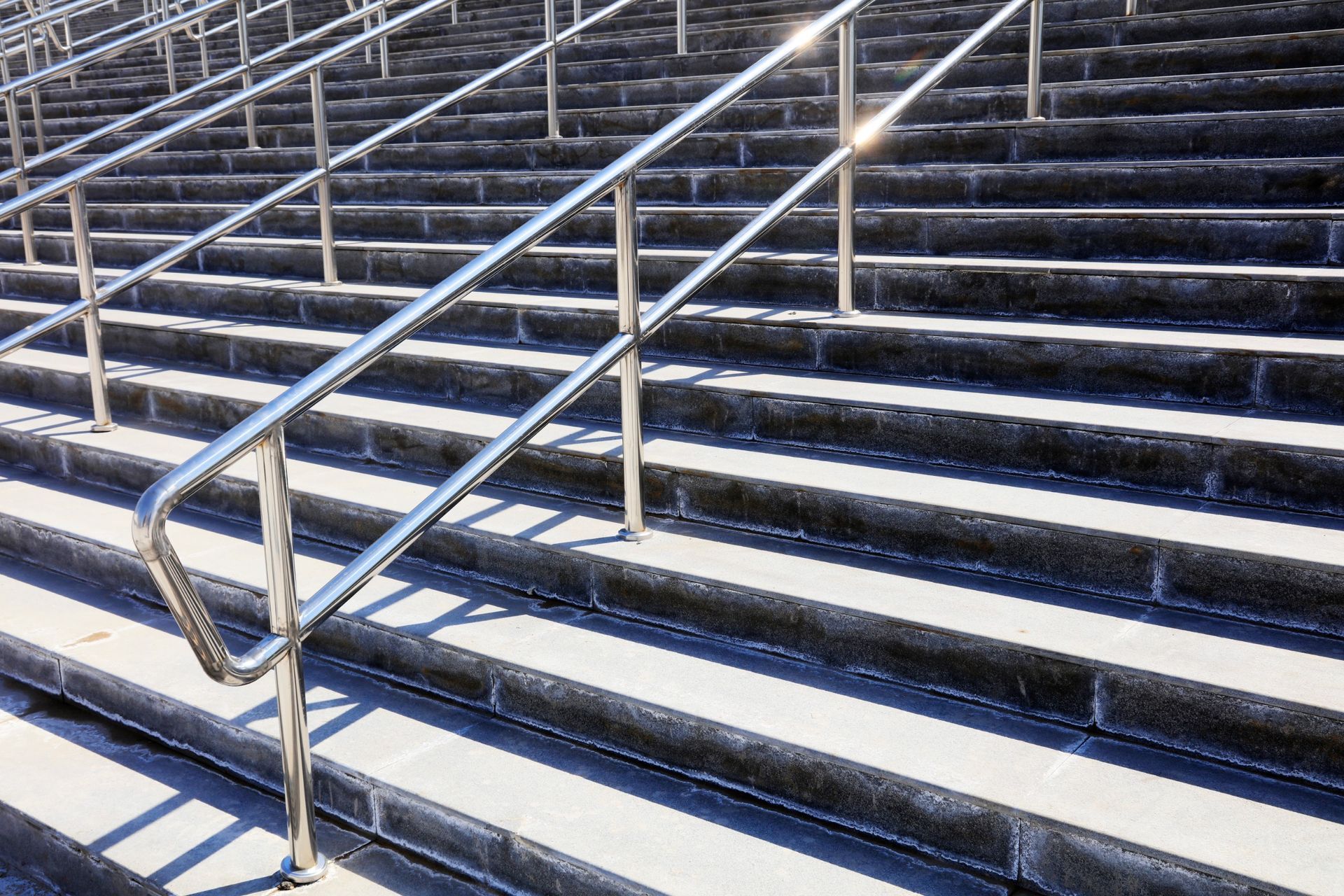 A close up of a set of stairs with a metal railing