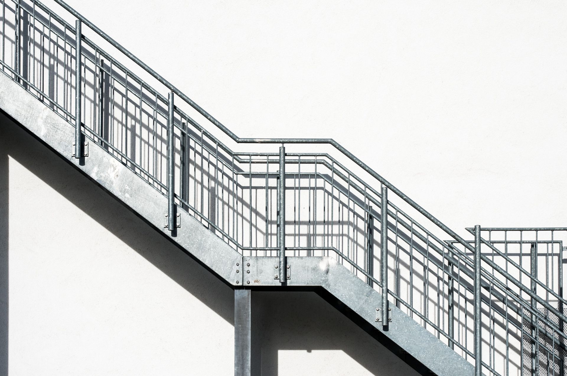 A metal staircase with a railing on a white background.