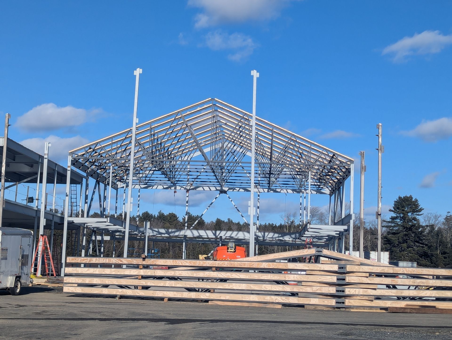 Partially built steel structure at a construction site under a blue sky