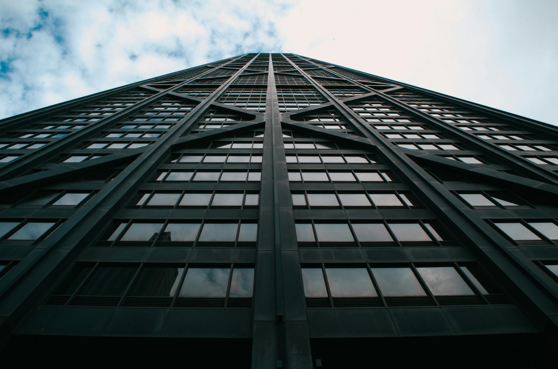Looking up at a tall building with a blue sky in the background.