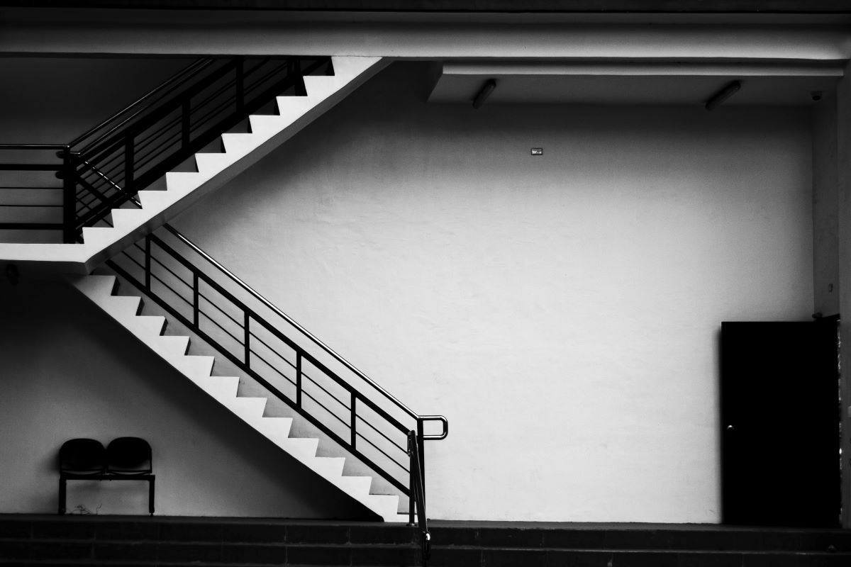 A black and white photo of a staircase in a building