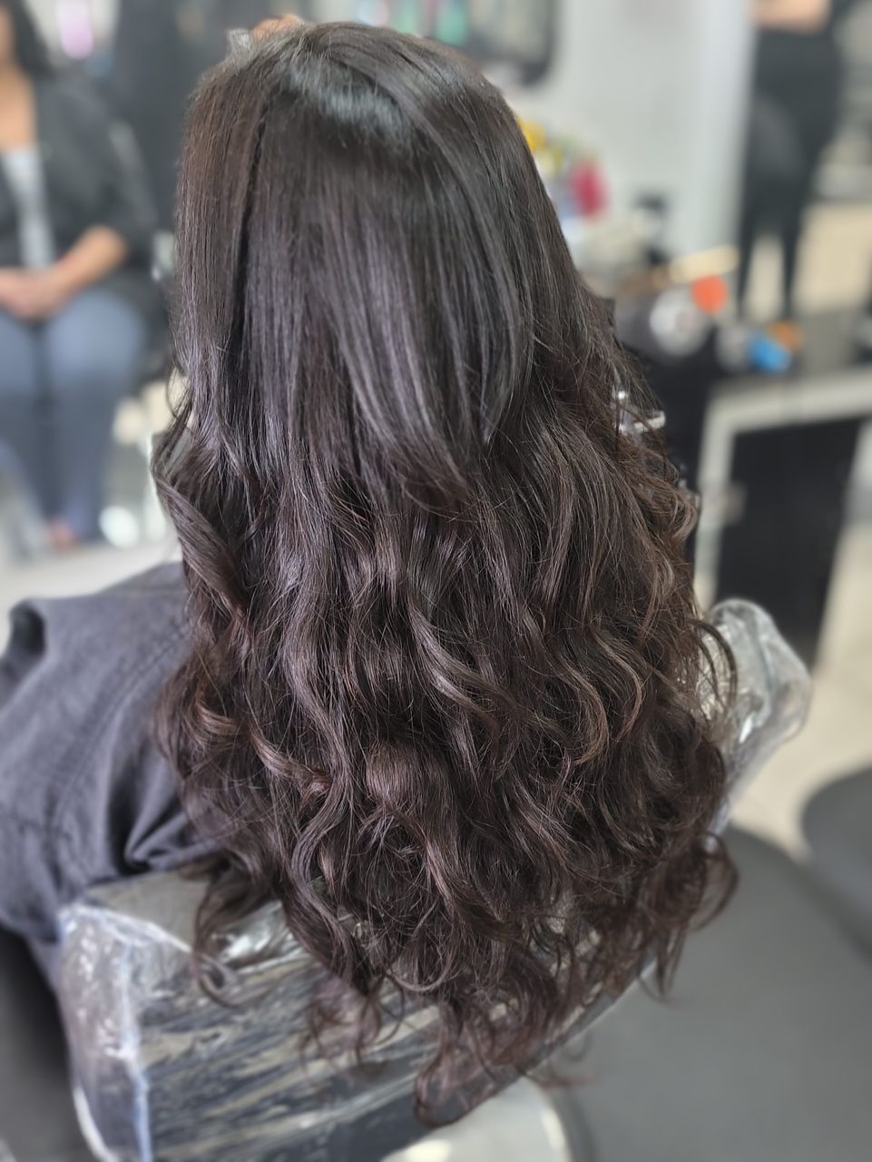 black curly hair extensions done at hair salon