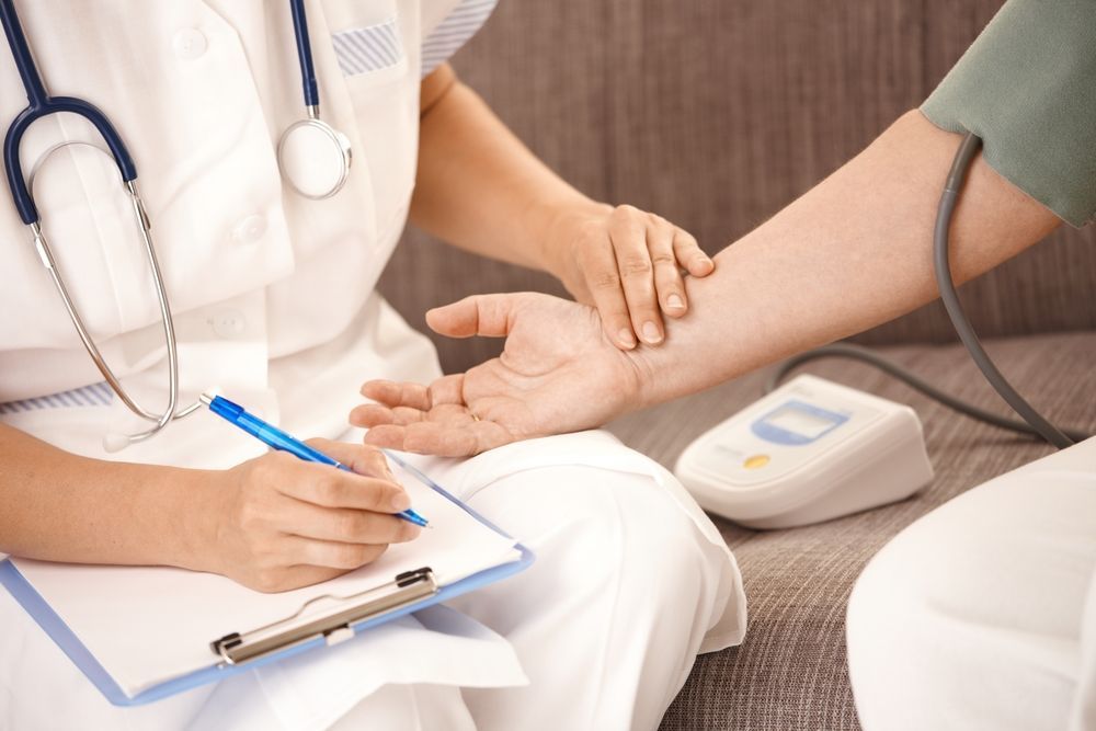 Doctor Taking Blood Pressure During a Clinic Appointment — Rainbow Beach General Practice in Rainbow Beach, QLD