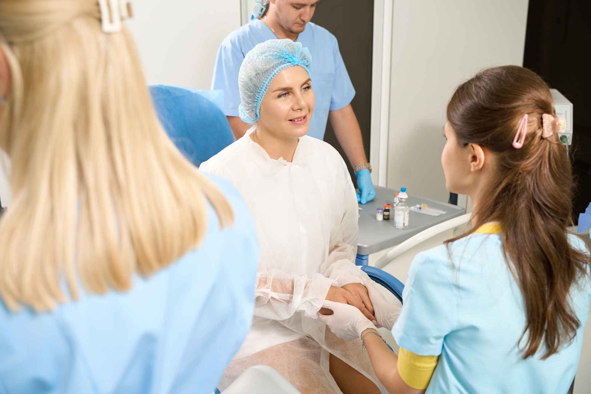 Medical Staff Speaking with A Seated Patient in A Clinic Room — Rainbow Beach General Practice in Rainbow Beach, QLD