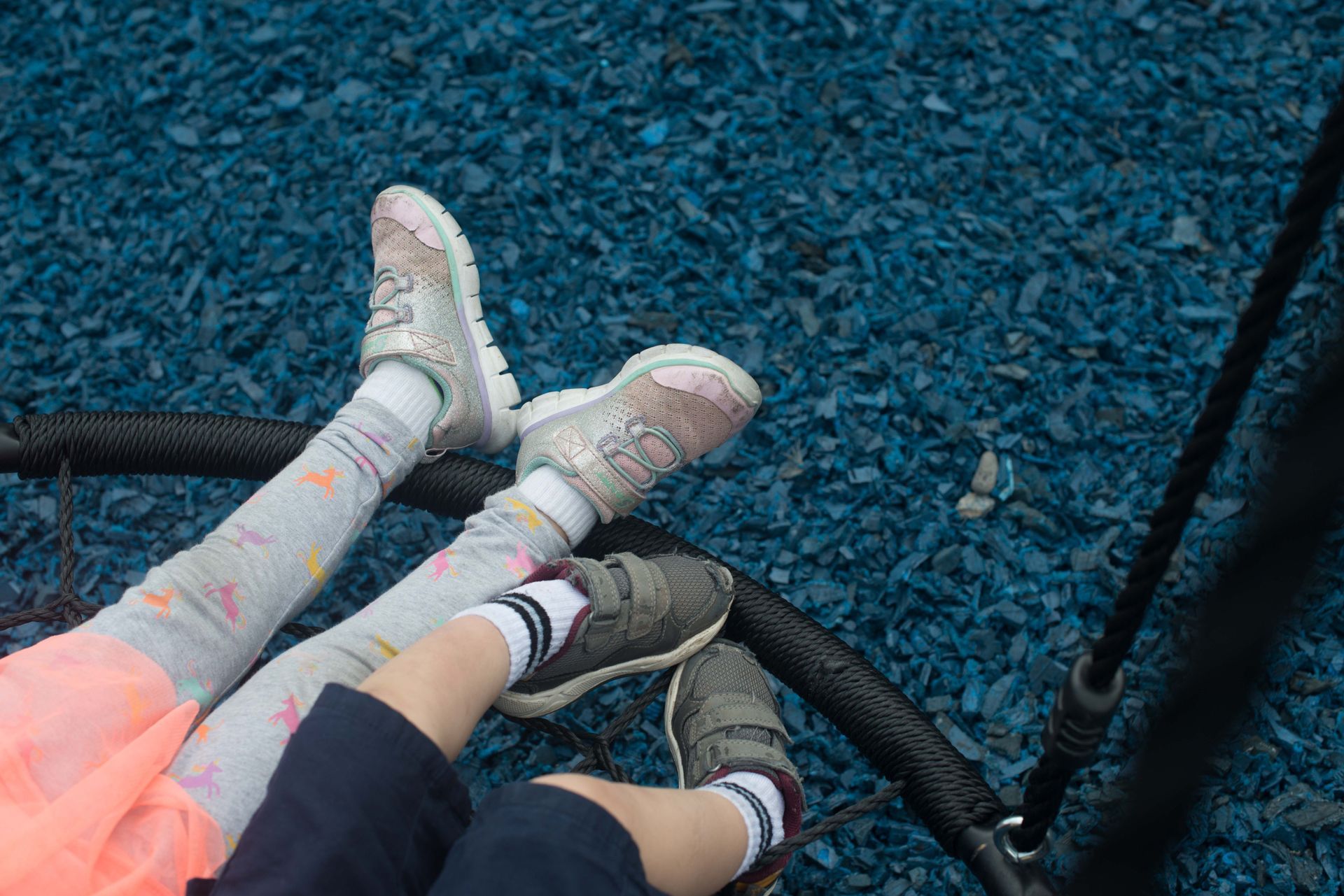 Wood chip mulch covering the ground beneath playground equipment