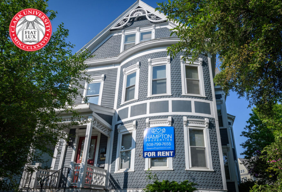 A large house with a for rent sign on it