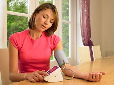 Woman taking blood pressure
