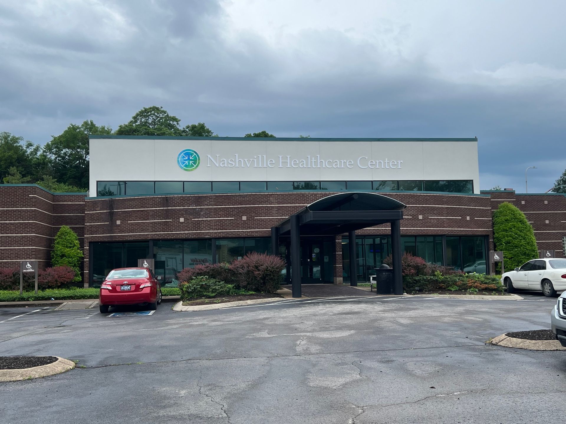 Exterior of Statesville Healthcare Center with red car parked out front.
