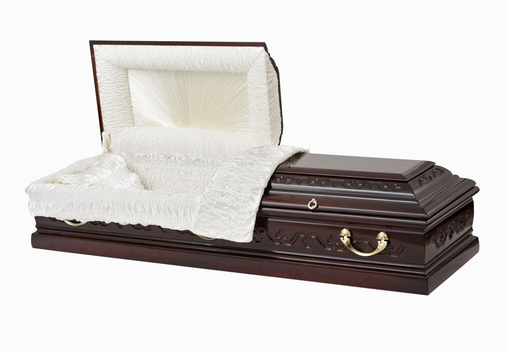 Open casket with white satin lining on a dark wooden coffin