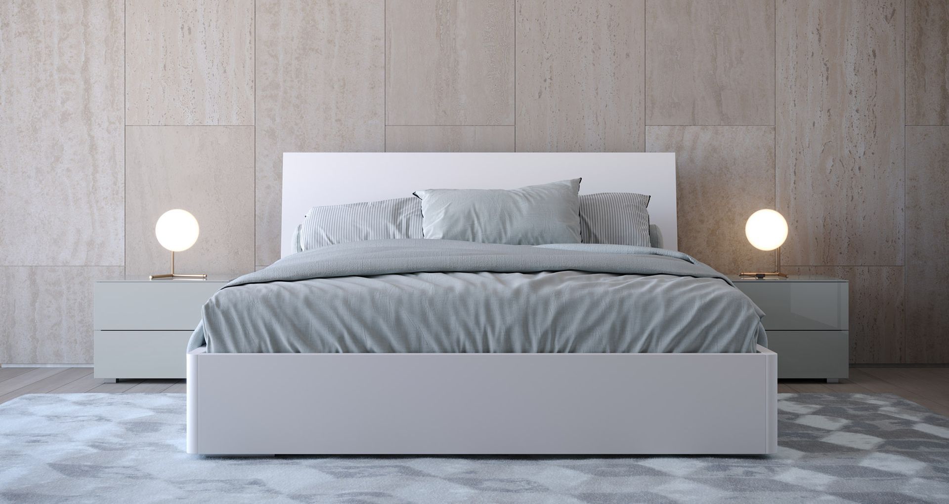 Camera da letto con letto bianco, biancheria grigia, due lampade da comodino e una parete neutra.