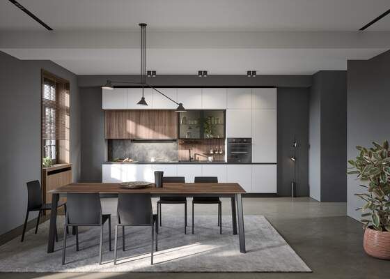Cucina e sala da pranzo moderne con tavolo in legno, pareti grigie e mobili bianchi.