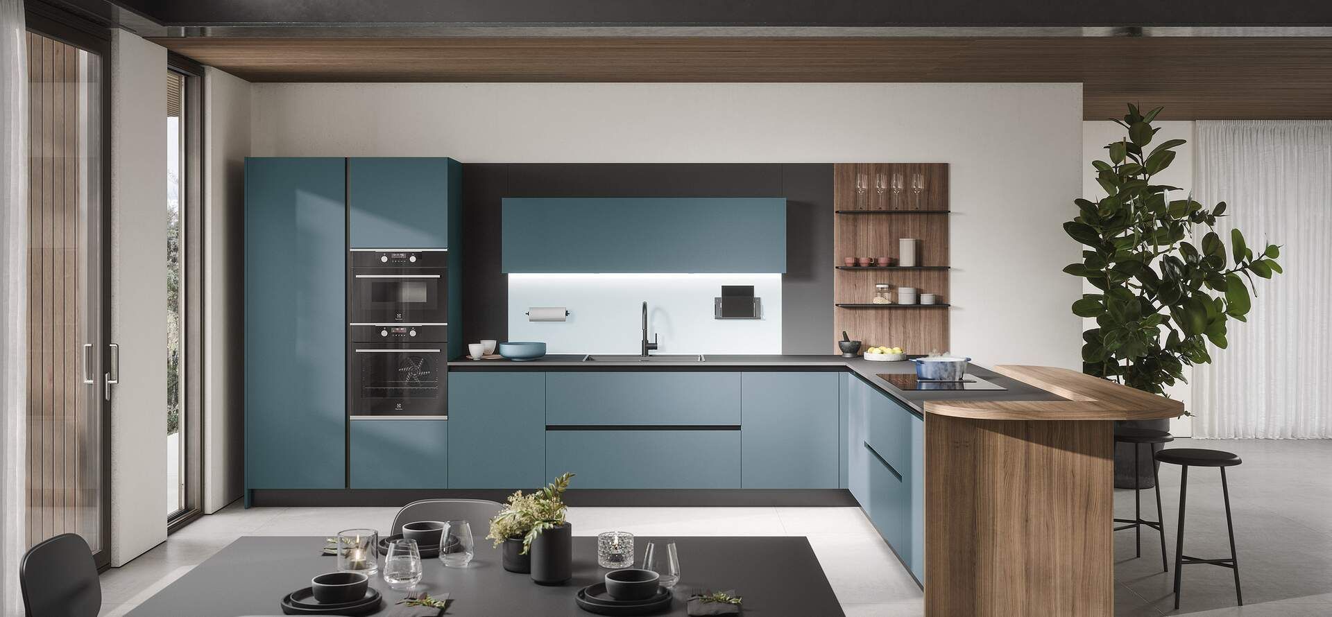 Cucina moderna con mobili color verde acqua, isola in legno e tavolo da pranzo.